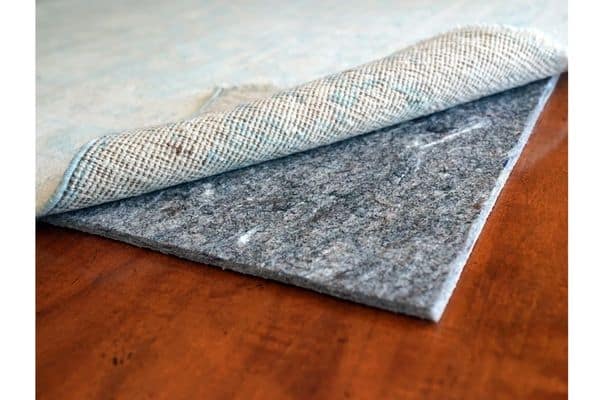 how to keep area rug from bunching up on carpet